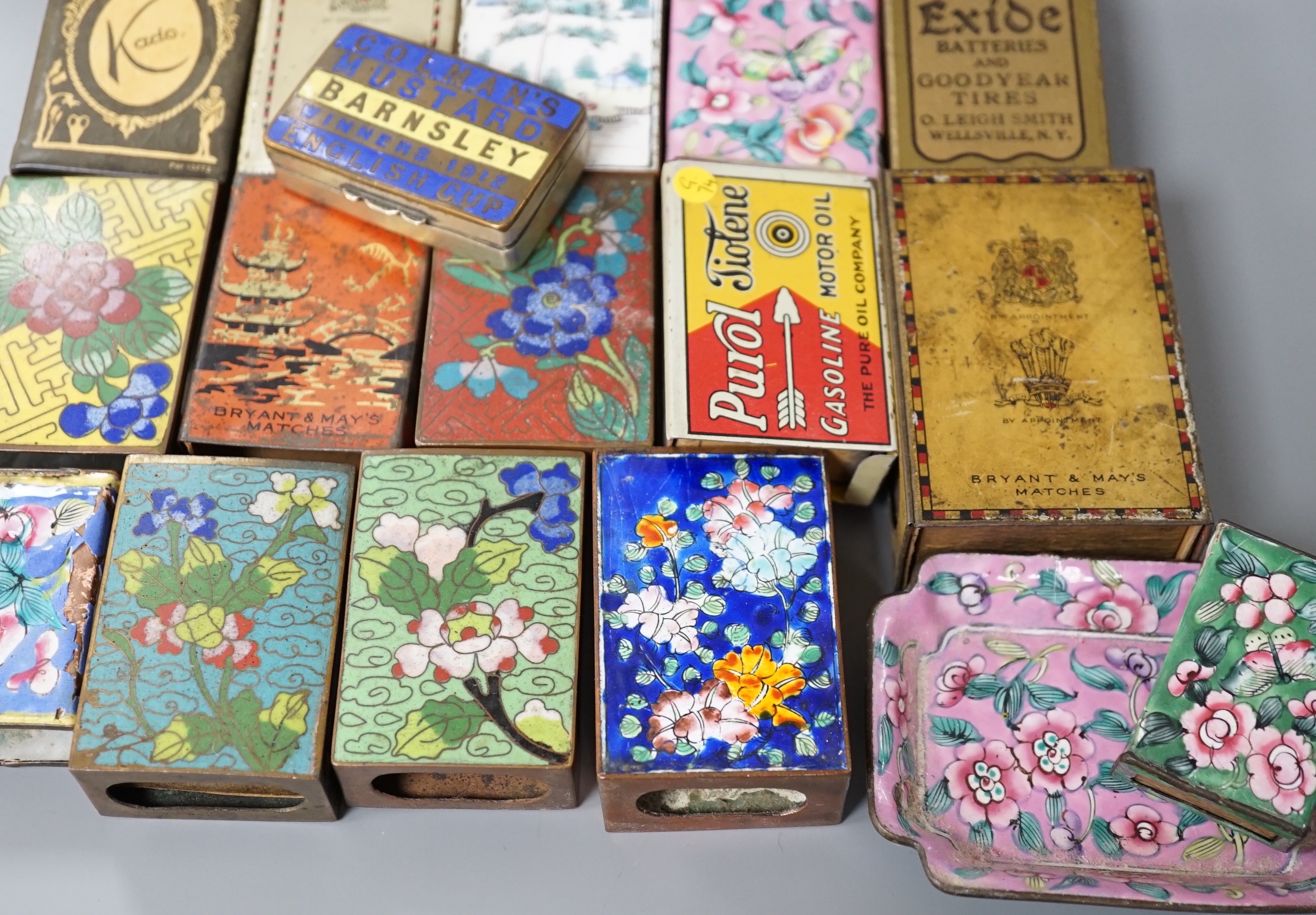 A collection of advertising and other enamelled metal match box holders